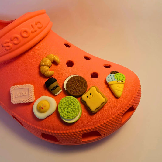 Snack-themed Croc charms featuring fun designs like chips, candy, and popcorn for a playful touch.